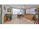 Bright, sunlit living room with tiled flooring, seating area, and casual decor at 8702 Congress St, Port Richey, FL 34668