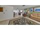 Open-concept living area with tile flooring, comfortable seating, and ample natural light at 8702 Congress St, Port Richey, FL 34668