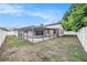 Fenced backyard with a pool and screened-in patio, offering private outdoor living at 8744 Andros Ln, Port Richey, FL 34668