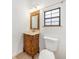 Half bath featuring decorative vanity and framed mirror at 8744 Andros Ln, Port Richey, FL 34668