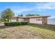 Charming single-story home boasts stone accents, a two-car garage, and a well-manicured front yard at 8744 Andros Ln, Port Richey, FL 34668