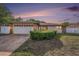Charming single-story home boasts stone accents, a two-car garage, and a well-manicured front yard at 8744 Andros Ln, Port Richey, FL 34668