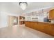 Open kitchen with a large countertop, tile floors, and a decorative chandelier above at 8744 Andros Ln, Port Richey, FL 34668