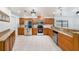 Well-equipped kitchen features stainless steel appliances, granite countertops, and custom wood cabinets at 8744 Andros Ln, Port Richey, FL 34668