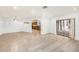 Spacious living room with an open layout featuring wood flooring and tile flooring, and backyard access at 8744 Andros Ln, Port Richey, FL 34668