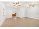 Open living room area with tile floors and decorative inlays leads to kitchen at 8744 Andros Ln, Port Richey, FL 34668