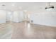 Bright living room featuring neutral tile floors, recessed lighting, and a decorative chandelier at 8744 Andros Ln, Port Richey, FL 34668