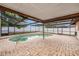Inviting kidney-shaped pool with a screened enclosure and a spacious brick-paved patio at 8744 Andros Ln, Port Richey, FL 34668