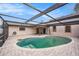 The kidney-shaped pool is surrounded by brick pavers and a screened enclosure for outdoor enjoyment at 8744 Andros Ln, Port Richey, FL 34668