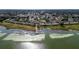 Aerial view of lakeside condo community with boat dock and mature trees at 9209 Seminole Blvd # 156, Seminole, FL 33772