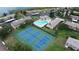 Aerial shot showcasing tennis courts, pool, and surrounding residential buildings in the community at 9209 Seminole Blvd # 156, Seminole, FL 33772