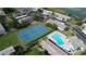 Aerial view of the condo community showing tennis courts and a refreshing outdoor pool at 9209 Seminole Blvd # 156, Seminole, FL 33772