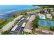 Beautiful aerial view of townhomes with lake access, tennis courts, and community pool at 9209 Seminole Blvd # 156, Seminole, FL 33772