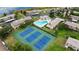 Community aerial shot featuring a swimming pool, tennis courts and lake at 9209 Seminole Blvd # 156, Seminole, FL 33772