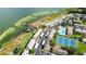 Aerial view of lakeside condo community with a dock and covered parking at 9209 Seminole Blvd # 156, Seminole, FL 33772