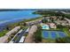 Aerial view of community with tennis courts, pool and lake access at 9209 Seminole Blvd # 156, Seminole, FL 33772