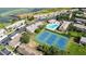 Aerial view of community amenities including pool, tennis courts, and parking areas, nestled within manicured landscaping near waterfront at 9209 Seminole Blvd # 156, Seminole, FL 33772