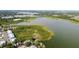 Aerial view of condo community near a large lake with lush greenery at 9209 Seminole Blvd # 156, Seminole, FL 33772
