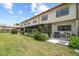 Spacious backyard with a patio, lush greenery, and an exterior view of the townhome at 9209 Seminole Blvd # 156, Seminole, FL 33772
