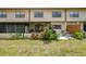 Well-maintained backyard and patio with verdant shrubs and a glimpse into screened-in porch at 9209 Seminole Blvd # 156, Seminole, FL 33772