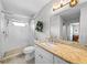 Bathroom featuring a glass-enclosed shower and a vanity with granite countertops at 9209 Seminole Blvd # 156, Seminole, FL 33772