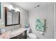 Well-lit bathroom featuring a decorative mirror, and modern fixtures at 9209 Seminole Blvd # 156, Seminole, FL 33772