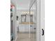 Hallway view of the double sink bathroom with bright lights and lots of storage at 9209 Seminole Blvd # 156, Seminole, FL 33772