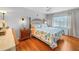 Bright bedroom with hardwood floors, ceiling fan, and ample natural light at 9209 Seminole Blvd # 156, Seminole, FL 33772