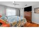 Comfortable bedroom featuring a large window, barn door closet, and ceiling fan at 9209 Seminole Blvd # 156, Seminole, FL 33772