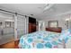 Bedroom features hardwood flooring, ceiling fan, closet, and attached bathroom at 9209 Seminole Blvd # 156, Seminole, FL 33772