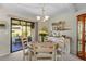 Well-lit dining area with a round table, decorated with flowers, and an adjacent screened-in porch at 9209 Seminole Blvd # 156, Seminole, FL 33772