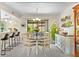 Bright dining room with a chandelier above the table and a view of the backyard at 9209 Seminole Blvd # 156, Seminole, FL 33772