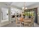 Charming dining area next to a stylish kitchen with barstool seating and natural outdoor views at 9209 Seminole Blvd # 156, Seminole, FL 33772