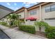 Exterior view of a well-maintained condo with lush landscaping and a private patio area at 9209 Seminole Blvd # 156, Seminole, FL 33772