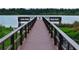 Scenic view of wooden boardwalk and lake enhancing the property's curb appeal at 9209 Seminole Blvd # 156, Seminole, FL 33772