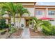 Inviting two-story townhouse with lush tropical landscaping and a charming front entryway at 9209 Seminole Blvd # 156, Seminole, FL 33772