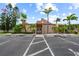 Exterior of community clubhouse featuring ample parking and lush landscaping enhancing curb appeal at 9209 Seminole Blvd # 156, Seminole, FL 33772