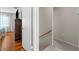 Hallway with stairs leading to a bedroom featuring hardwood floors and closet at 9209 Seminole Blvd # 156, Seminole, FL 33772