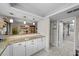 A bright kitchen and bar area with granite countertops and modern white cabinetry and stainless appliances at 9209 Seminole Blvd # 156, Seminole, FL 33772