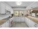 Well-lit kitchen features granite counters, white appliances, and plenty of cabinet space at 9209 Seminole Blvd # 156, Seminole, FL 33772