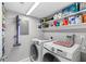 Organized laundry room equipped with modern washer and dryer units, storage shelves, and utility accessories at 9209 Seminole Blvd # 156, Seminole, FL 33772