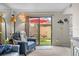 Cozy living room with access to a private patio featuring a red umbrella and outdoor seating at 9209 Seminole Blvd # 156, Seminole, FL 33772