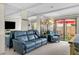 Cozy living room featuring a plush blue sofa and easy access to the outdoor patio at 9209 Seminole Blvd # 156, Seminole, FL 33772