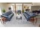 A spacious living room features stylish grey sofas, rug, and lots of natural light at 9209 Seminole Blvd # 156, Seminole, FL 33772