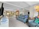 Spacious living room featuring neutral carpet, comfortable blue seating, and a mirrored wall for added dimension at 9209 Seminole Blvd # 156, Seminole, FL 33772