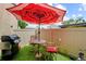 Cozy patio with an umbrella-covered table and grill, perfect for outdoor dining and entertaining at 9209 Seminole Blvd # 156, Seminole, FL 33772