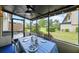 The screened-in porch features a table and seating overlooking the well-maintained backyard at 9209 Seminole Blvd # 156, Seminole, FL 33772