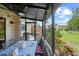 The screened-in porch offers a dining space overlooking the manicured lawn at 9209 Seminole Blvd # 156, Seminole, FL 33772