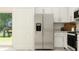 Well-lit kitchen featuring stainless steel refrigerator and white cabinets at 9333 Bonita Mar Dr, Parrish, FL 34219