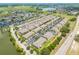 Community aerial view shows houses, landscaping, nearby lake and roadways at 9520 Trumpet Vine Loop, Trinity, FL 34655